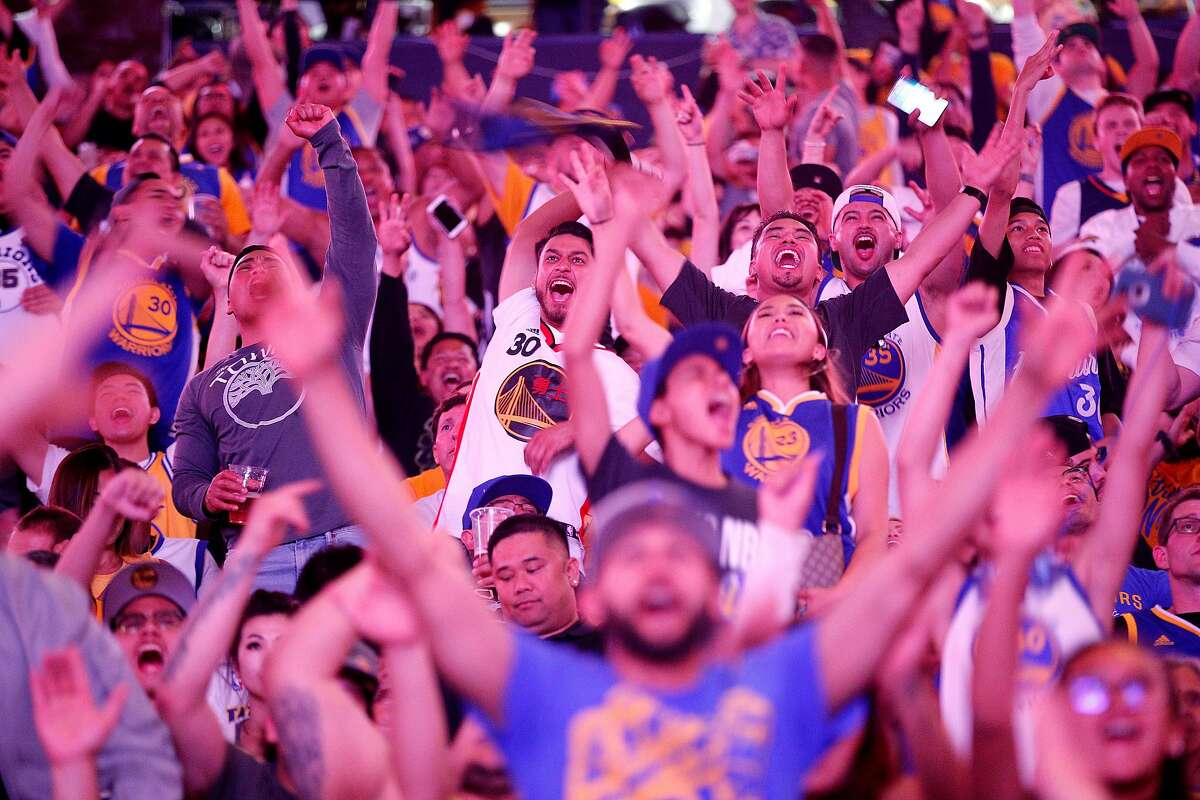 Fans cheer during a Golden State Warriors watch party at Oracle Arena, Friday, June 8, 2018, in Oakland, Calif. Visitors watched on the jumbotron Game 4 of the NBA Finals between the Warriors and Cleveland Cavaliers.