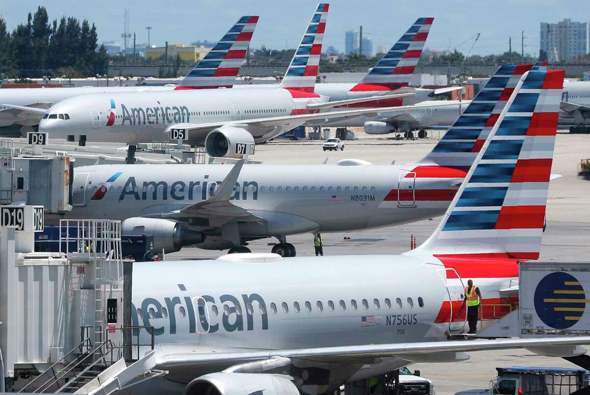 In this Wednesday, April 24, 2019, photo, American Airlines aircraft are shown parked at their gates at Miami International Airport in Miami. American Airlines is accusing its mechanics and their unions of conducting an illegal work slowdown to gain leverage in contract talks, and the airline is asking a federal judge to stop the activity.