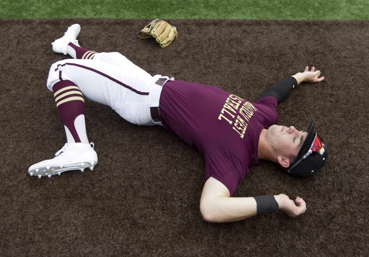 Magnolia West shortstop Zach Wall (8) warms up before Game 1 of a Region III-5A semifinal high school baseball series at Darryl & Lori Schroeder Park, Wednesday, May 22, 2019, in Houston.