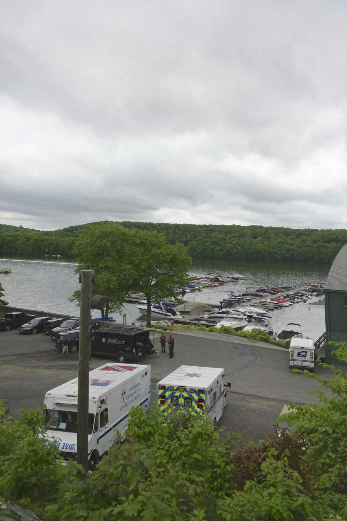 Search and rescue teams get ready to leave the parking lot of Gerard's Waters Edge Maria less than an hour after finding the body of Joshua Dasilva in Candlewood Lake on Wednesday. Officials had been searching for Dasilva, of New Milford, after he went missing while swimming with friends on Monday. May 29, 2019, in New Milford, Conn. Search and rescue efforts were based at the marina.