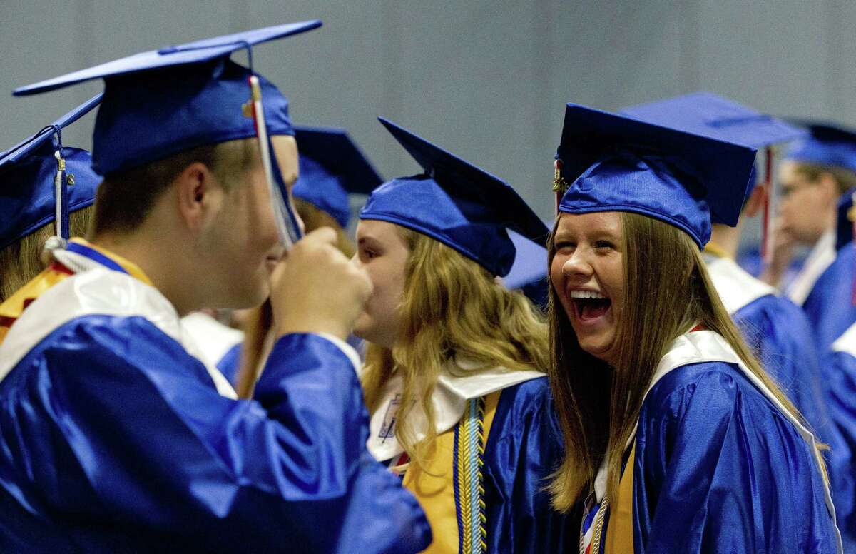 Elise Hogelin shares a laugh as she waits for the start of the Oak Ridge High School graduation ceremony at Cynthia Woods Mitchell Pavilion, Tuesday, May 28, 2019, in The Woodlands.