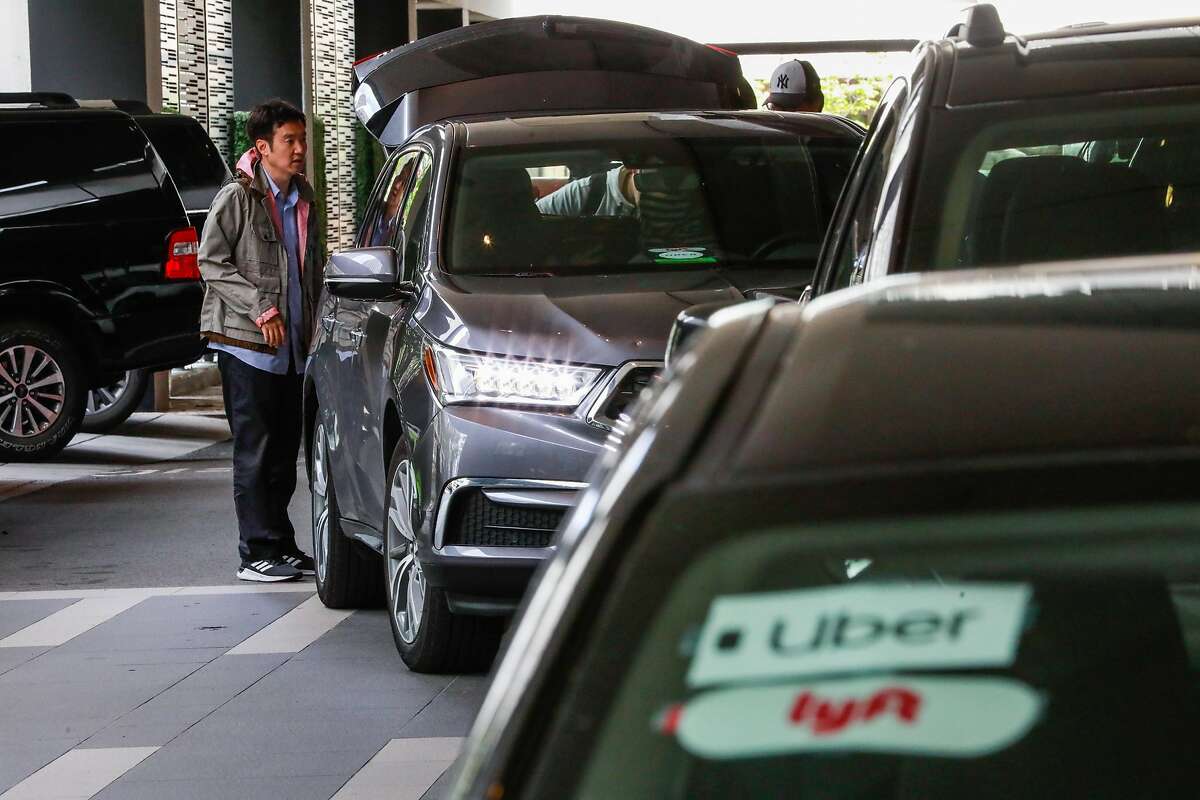 A line of transportation network vehicles at the Hyatt hotel in downtown San Francisco, California, on Monday, May 20, 2019. Author Paul Leigh explains why driving for one of these companies is one of the most dangerous jobs in the country.