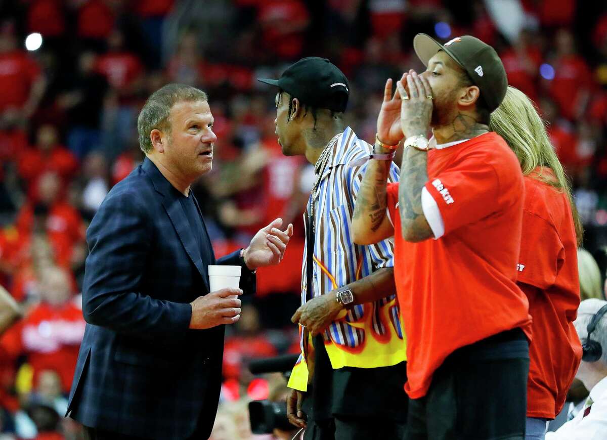 Rockets owner Tilman Fertitta talks to rapper Travis Scott during the third quarter of Game 3 of a NBA Western Conference semifinal playoff game at Toyota Center, in Houston , Saturday, May 4, 2019.