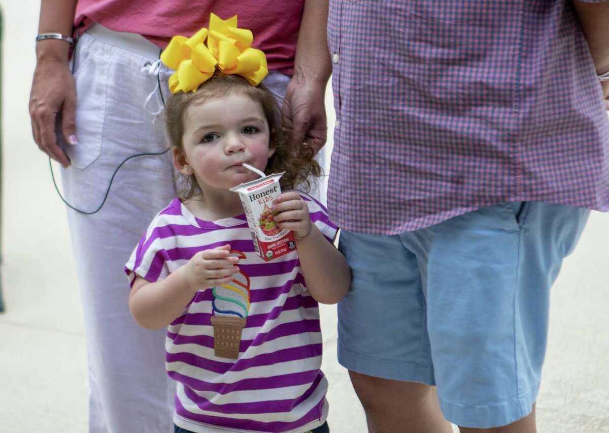 Lilly Machann, 2, sips from a juice box as her parents speak during a water safety and drowning prevention media day Wednesday, May 29, 2019 at Bear Branch Pool in The Woodlands. Lilly Machann survived a drowning accident in 2018 thanks to efforts from her parents and first responders.