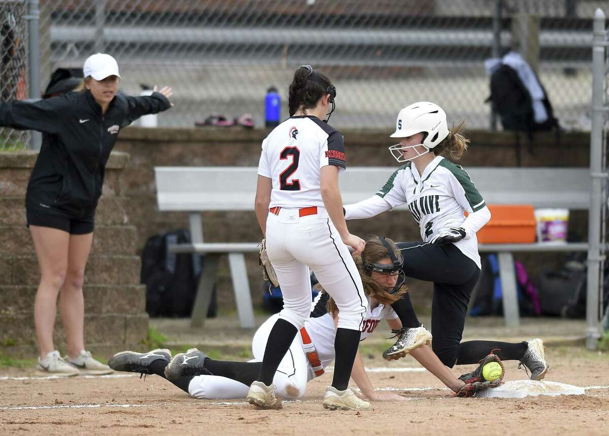 Stamford's Jordan Rossi tags the base for the out on New Milford's Sarah Mickelson in the second inning of a Class LL state tournament game Wednesday. Host Stamford won, 10-0.