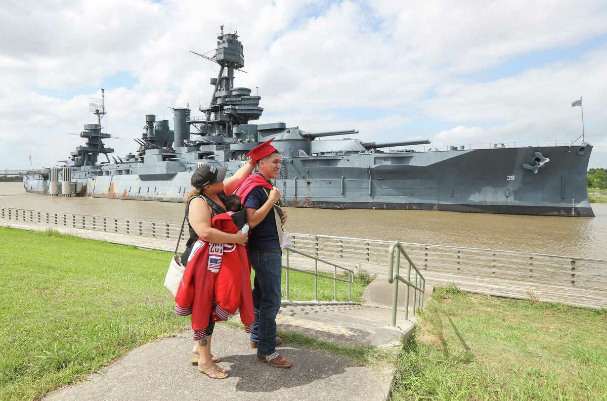 MacArthur High School graduate Daniel C. Herrera has help adjusting his cap by his mother, Lidia Herrera, during his photo session in front of the Battleship Texas Wednesday, May 29, 2019, in La Porte. Herrera has enlisted in the Navy and will ship out June 20th. The Battleship Texas will move from its historic site at the San Jacinto Battleground near La Porte, the head of the nonprofit that oversees the vessel said.