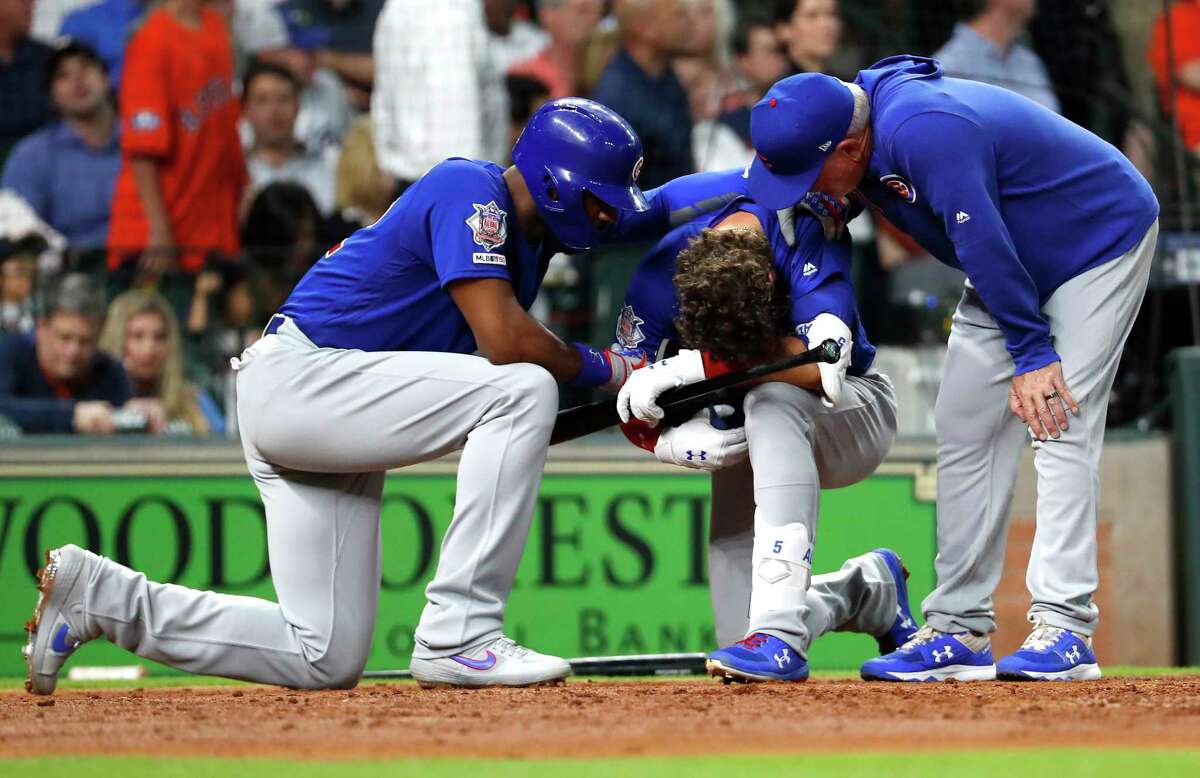 Chicago Cubs center fielder Albert Almora Jr., center, reacts after a foul ball he hit into the stands hit a small child during the fourth inning of a major league baseball game against the Houston Astros at Minute Maid Park on Wednesday, May 29, 2019, in Houston.