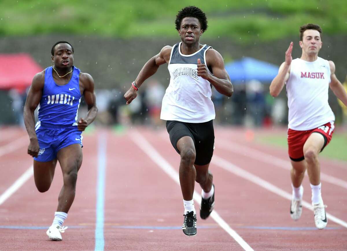 Neal Eley (center) of Hillhouse runs to a first place finish in the 100 meter dash finals in the CIAC Class MM Outdoor Track & Field Championship at Middletown High School on May 29, 2019.