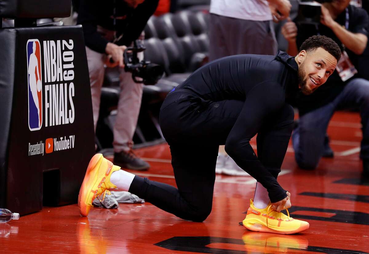 Golden State Warriors' Stephen Curry ties his shoes before practicing at ScotiaBank Arena in Toronto, Ontario, Canada, on Wednesday, May 29, 2019.