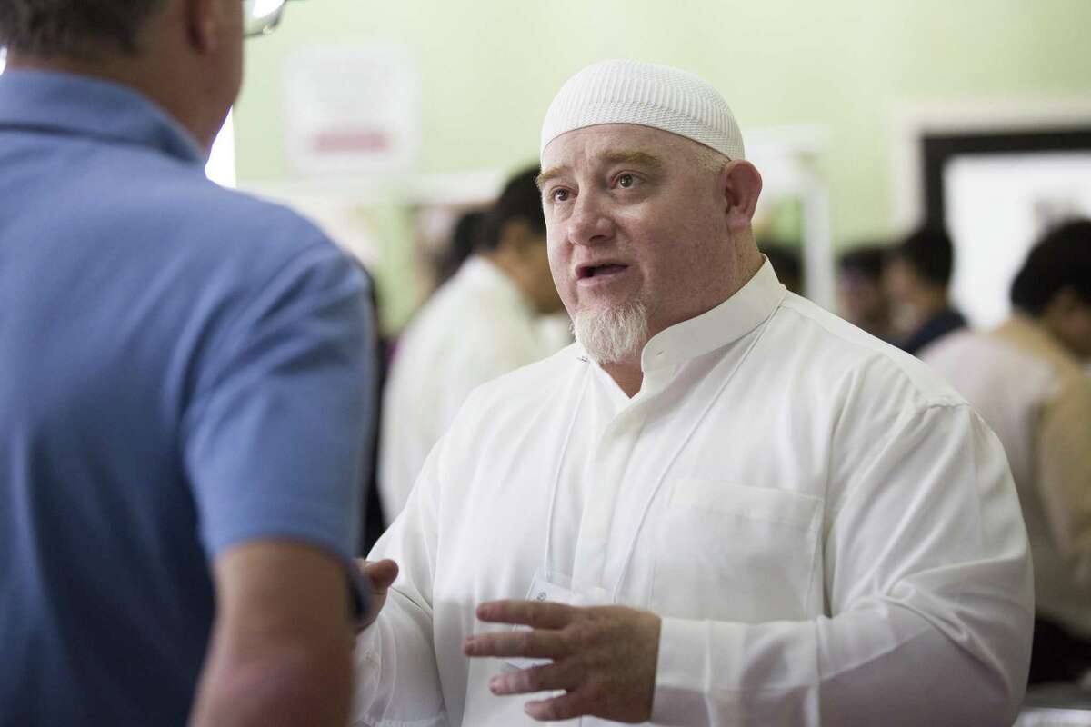 Kenny Bomer, right, an author who converted to Islam 31 years ago speaks to a mosque visitor (who didn't want to be identified) during a Open Mosque Day at Synott Islamic Center on Saturday, April 27, 2019, in Sugarland.