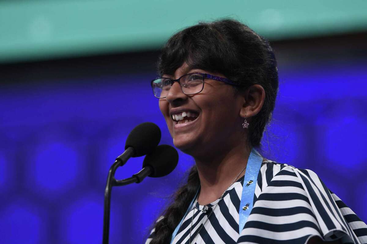 Harini Logan, 11, of San Antonio, smiles after correctly spelling her word as she competes in the finals of the Scripps National Spelling Bee in Oxon Hill, Md., Thursday, May 30, 2019. (AP Photo/Susan Walsh)