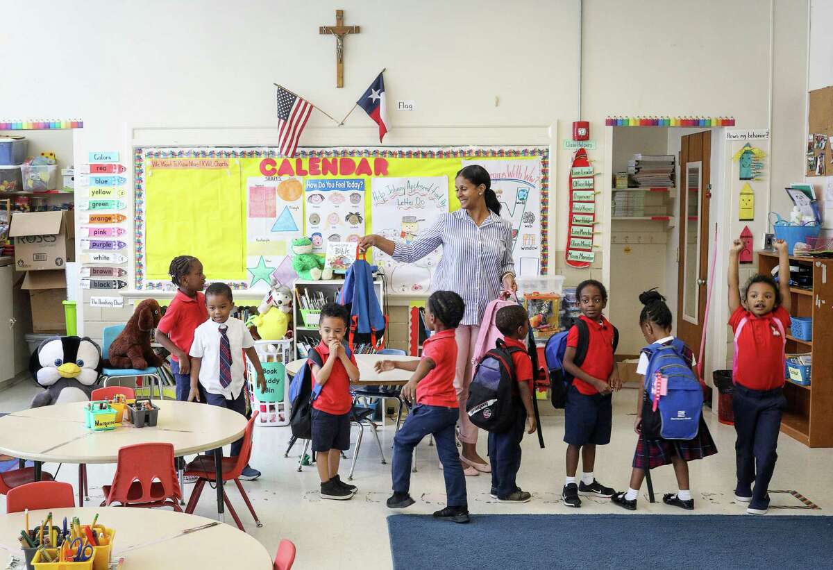 Julie Cook, center, readies her students for dismissal after a prayer at the end of the school day at Saint Peter the Apostle Catholic School on Tuesday, May 14, 2019, in Houston. The school closed last year because of low enrollment. This week, the Archdiocese of Galveston-Houston announced it would close four additional schools in Houston and Pasadena.