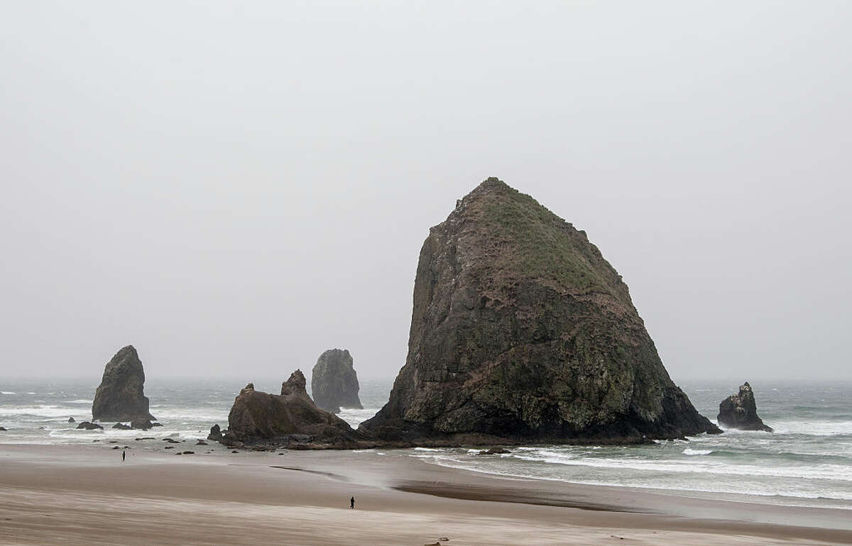 Cannon Beach, Oregon. Haystack rock, part of the Tolovana Beach State Recreation Site. . (Photo by: Education Images/UIG via Getty Images)