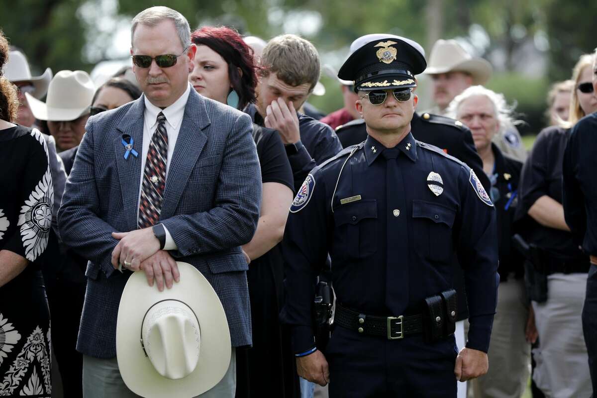 Midland County Sheriff's Office Chief Deputy Rory McKinney, left, and Midland Police Department Chief Seth Herman, right, look on during the funeral for Midland County Sheriff Gary Painter May 30, 2019 at Resthaven Memorial Park. James Durbin/Reporter-Telegram