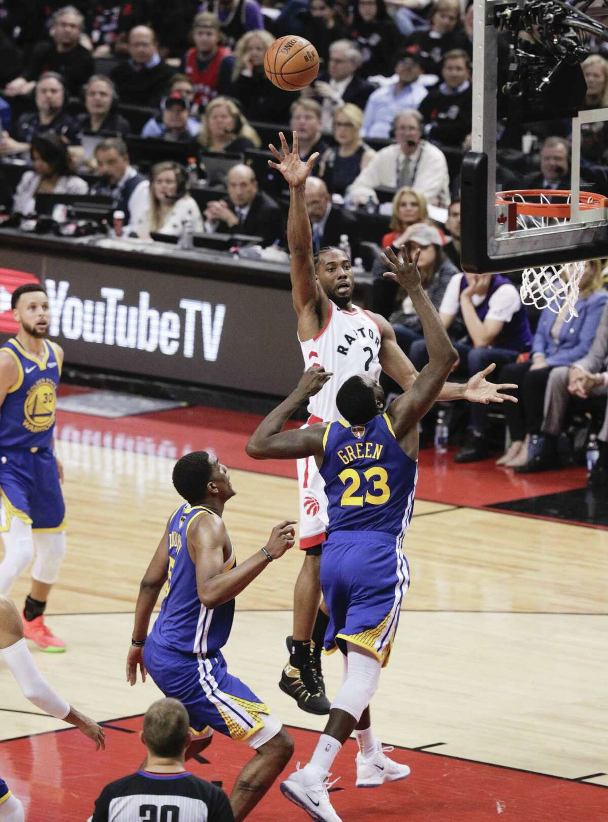 Toronto Raptors’ Kawhi Leonard shoots over Golden State Warriors’ Draymond Green in the third quarter during game 1 of the NBA Finals between the Golden State Warriors and the Toronto Raptors at Scotiabank Arena on Thursday, May 30, 2019 in Toronto, Ontario, Canada.