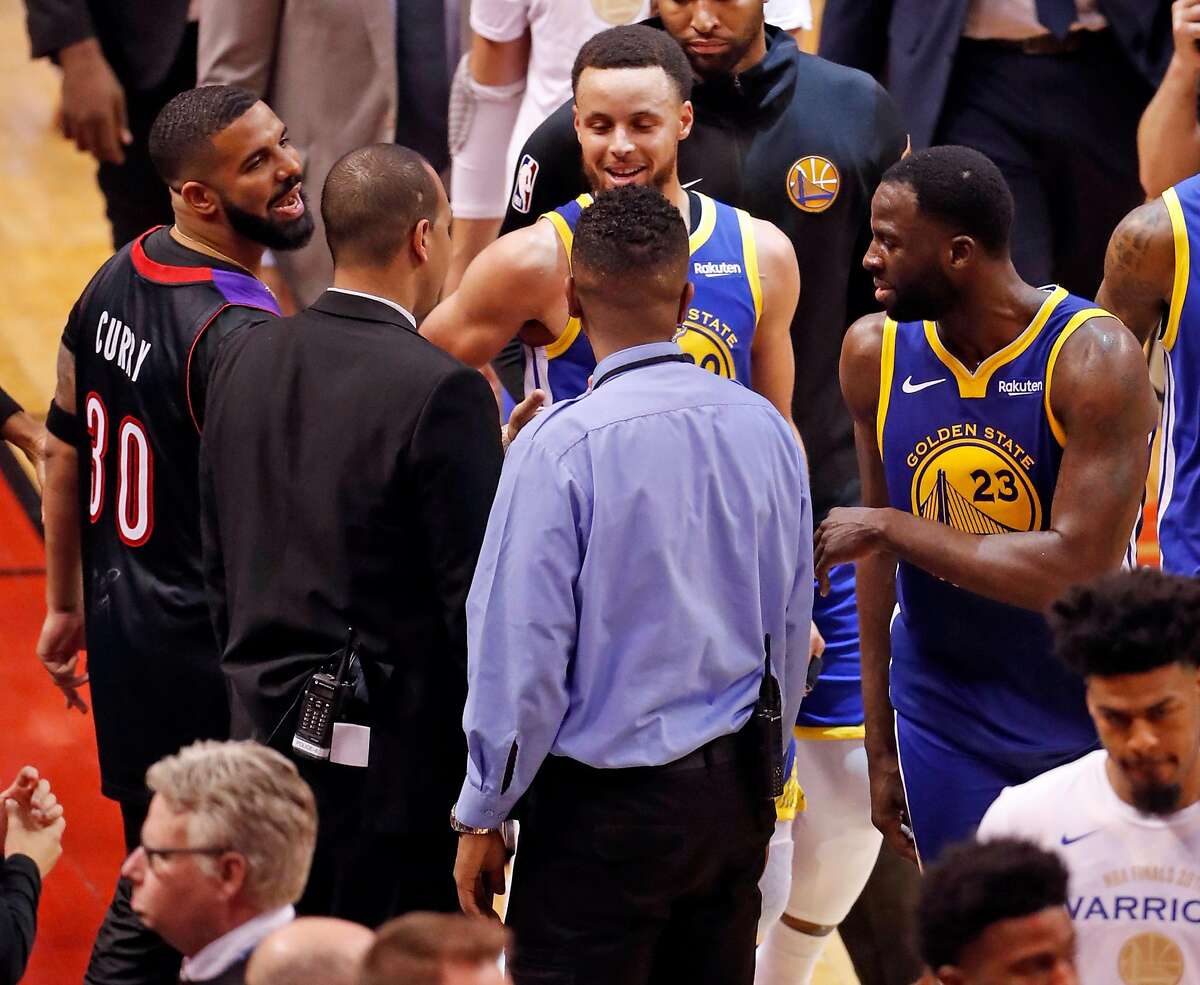 Drake and Golden State Warriors' Draymond Green exchange words after Toronto's 118-109 win in NBA Finals' Game 1 at ScotiaBank Arena in Toronto, Ontario, Canada, on Thursday, May 30, 2019.
