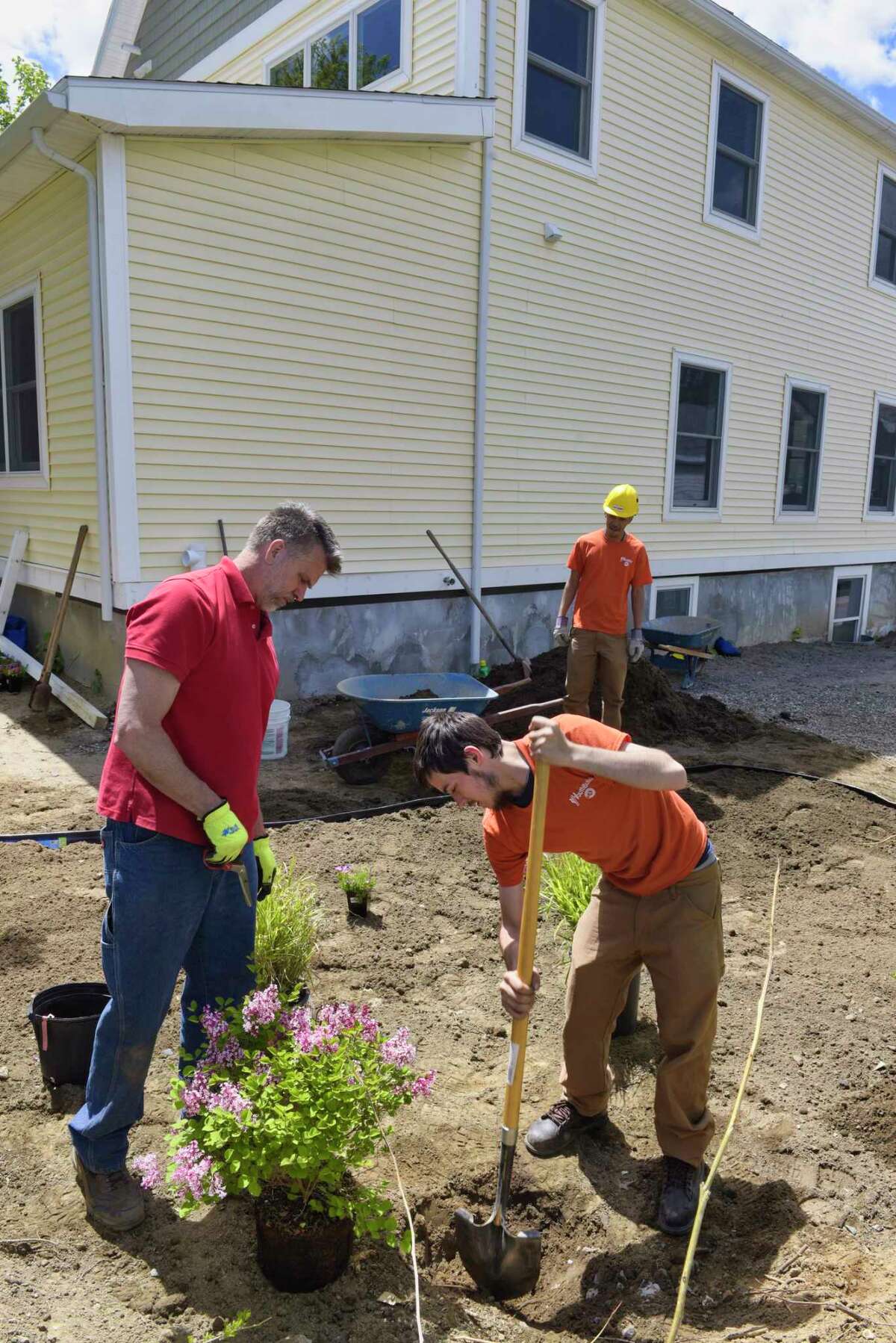 George Brower, left, construction manager for SEAT works with Youth Build's Lucas Marriner, foreground, and Anthony Bellamy, as they construct a rain garden at the Youth Build Affordable Homes project on Tuesday, May 21, 2019, in Schenectady, N.Y. (Paul Buckowski/Times Union)