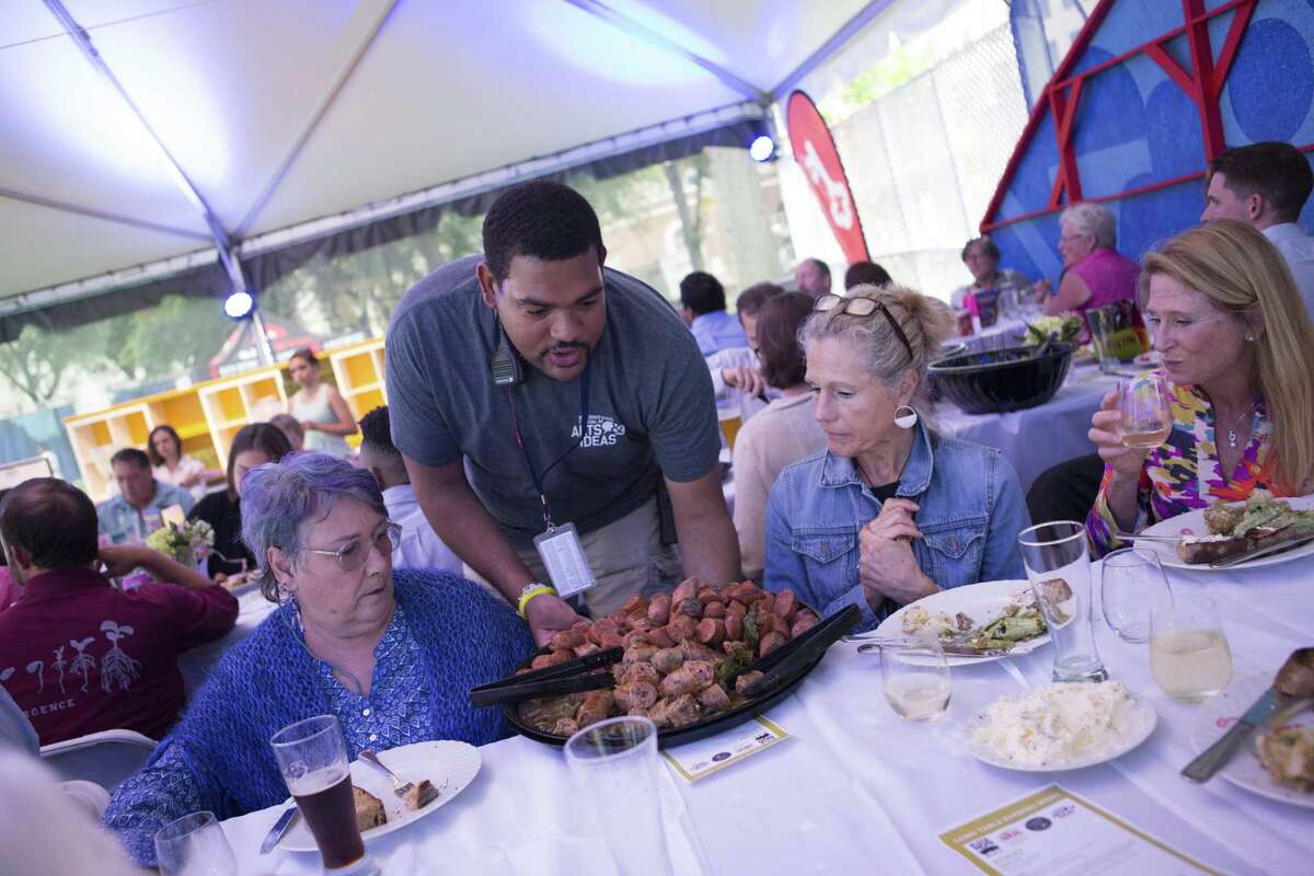 Food is served under the tent on the New Haven Green during an Arts & Ideas food event in 2018.
