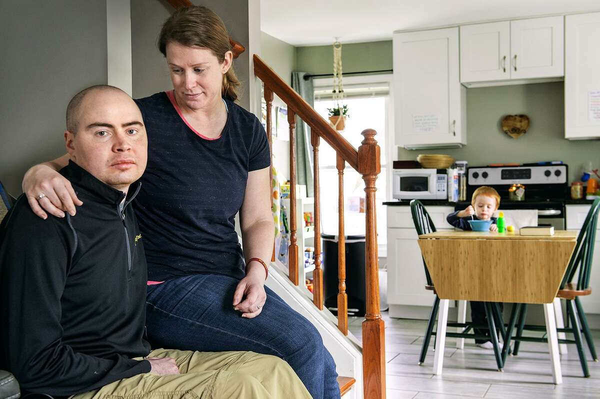 Peter and Amy Antioho in their Berlin home with their son, Mark, 3, in the background.