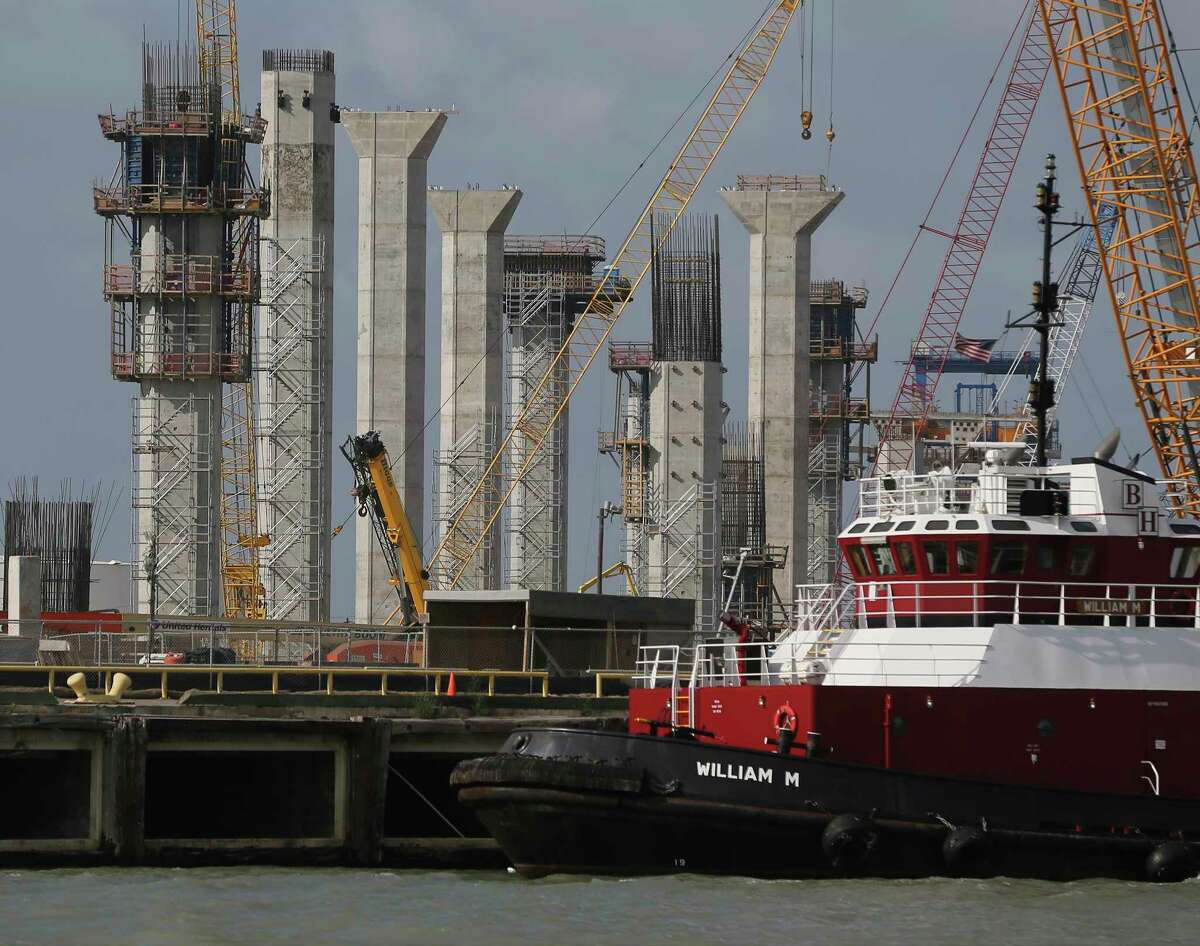 Work progresses as columns of the new Harbor Bridge in Corpus Christi are seen on Tuesday, May 28, 2019. Corpus Christi is becoming a major port for the export of oil from the Permain Basin and The Eagle Ford. One of the big players is NuStar Energy which operates four docks along the Corpus Christi industrial canal. Like many energy storage companies, NuStar is looking forward to the completion of several projects at the canal such as the new Harbor Bridge project which will allow for bigger vessels to pass into the canal and thus can take on more barrels of oil for shipment and a new and larger pipeline which will feed into NuStar's 400-series tank farm. Projects that the new bridge and new pipelines are cementing Corpus Christi as an emerging port of commerce in the energy sector. (Kin Man Hui/San Antonio Express-News)