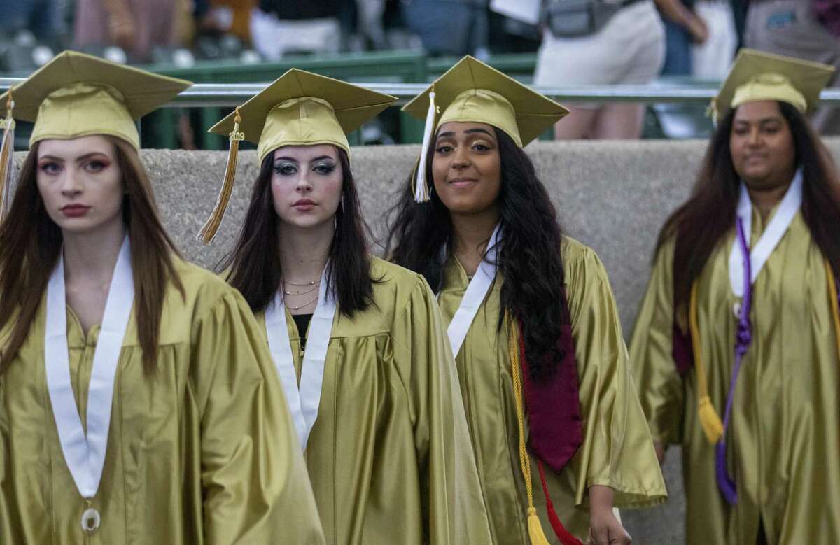 Conroe seniors make their way to their seats during a graduation ceremony Wednesday, May 29, 2019 at The Cynthia Woods Mitchell Pavilion in The Woodlands.