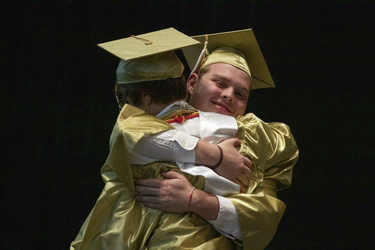 Conroe salutatorian Kyle Mrosko hugs valedictorian Preston Hart as Hart prepares to walk the stage during a graduation ceremony Wednesday, May 29, 2019 at The Cynthia Woods Mitchell Pavilion in The Woodlands.
