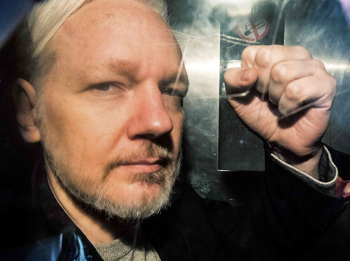 (FILES) In this file photo taken on May 01, 2019 WikiLeaks founder Julian Assange gestures from the window of a prison van as he is driven out of Southwark Crown Court in London, after having been sentenced to 50 weeks in prison for breaching his bail conditions in 2012. - Julian Assange has been subjected to drawn-out "psychological torture", a UN rights expert said May 31, 2019, accusing the United States, Britain, Ecuador and Sweden of "collective persecution" of the WikiLeaks founder. The United Nations special rapporteur on torture and other cruel, inhuman or degrading treatment, Nils Melzer, also warned that if London agrees to an extradition request from Washington, Assange risked the death penalty. (Photo by Daniel LEAL-OLIVAS / AFP)DANIEL LEAL-OLIVAS/AFP/Getty Images