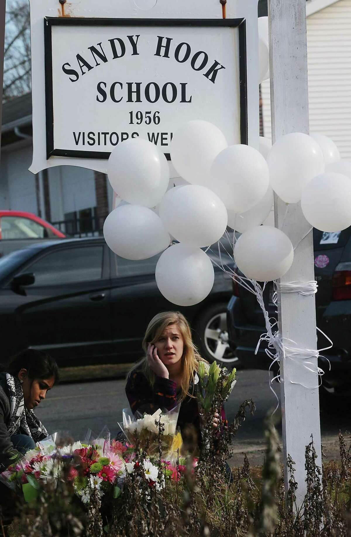 FILE - NOVEMBER 25, 2013: A report will be released today by Connecticut State Attorney Stephen Sedensky III summarizing the December 14, 2012 Newtown school shooting that left 20 children and six women dead inside Sandy Hook Elementary School November 25, 2013. NEWTOWN, CT - DECEMBER 15: People gather at a makeshift memorial outside a firehouse which was used as a staging area for families following the mass shooting at Sandy Hook Elementary School on December 15, 2012 in Newtown, Connecticut. Twenty six people were shot dead, including twenty children, after a gunman identified as Adam Lanza in news reports opened fire in the school. Lanza also reportedly had committed suicide at the scene. (Photo by Mario Tama/Getty Images)