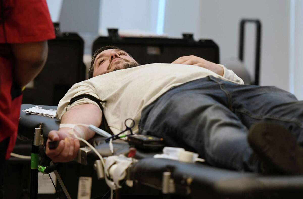Matthew Peter gives blood during a blood drive in memory of Detective Jason Martin on Friday, April 26, 2019 at the Albany Capital Center in Albany, NY. Detective Jason Martin was a lifelong resident of Albany who worked for the city for 20 years and died last year of lung cancer. (Phoebe Sheehan/Times Union)