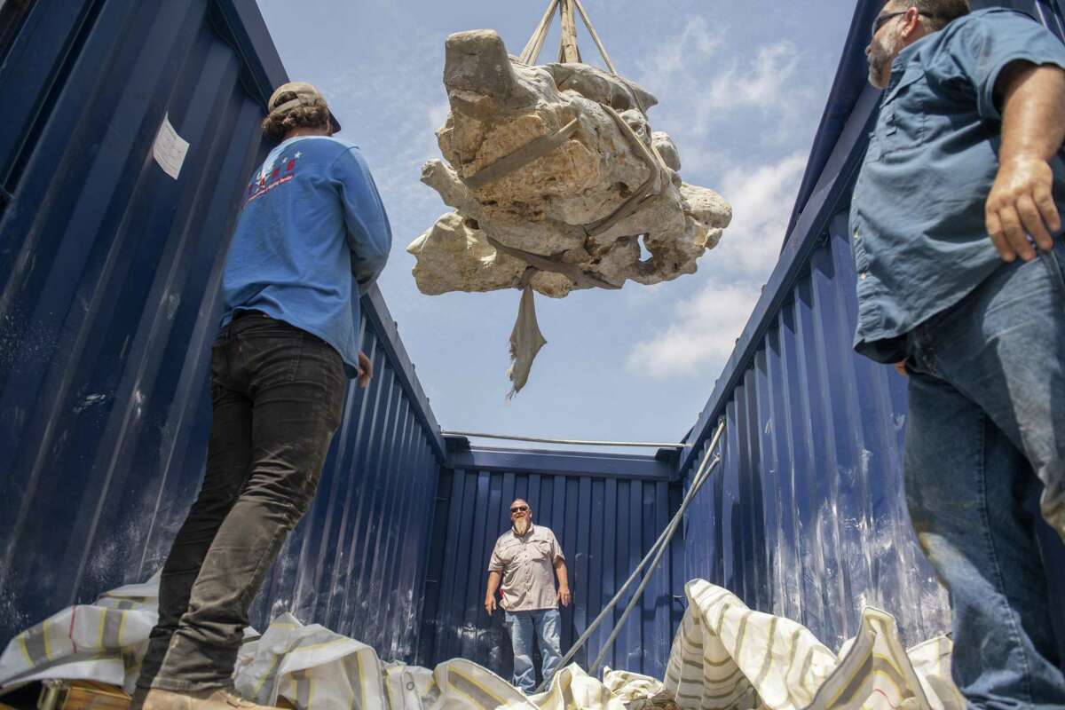 A crane hoists a six-and-a-half-ton Scholars’ Rock from a container on the back of a truck on Friday. The rock is a Tricentennial gift to the city from Wuxi, China, one of San Antonio’s sister cities.