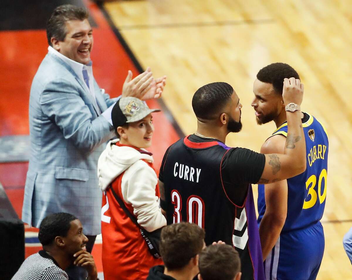 Drake picks something out of Golden State Warriors’ Stephen Curry during a break in the action in the first quarter during game 1 of the NBA Finals between the Golden State Warriors and the Toronto Raptors at Scotiabank Arena on Thursday, May 30, 2019 in Toronto, Ontario, Canada.