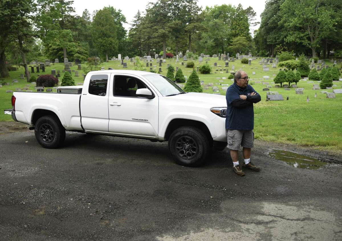 Harry Catanzaro parks his truck near a rough patch in the raod at St. Mary Cemetery in Greenwich, Conn. Wednesday, May 29, 2019. Catanzaro is worried about upkeep of the cemetery and has started mowing his family's plot by himself ever since St. Mary's cut their maintenance staff.