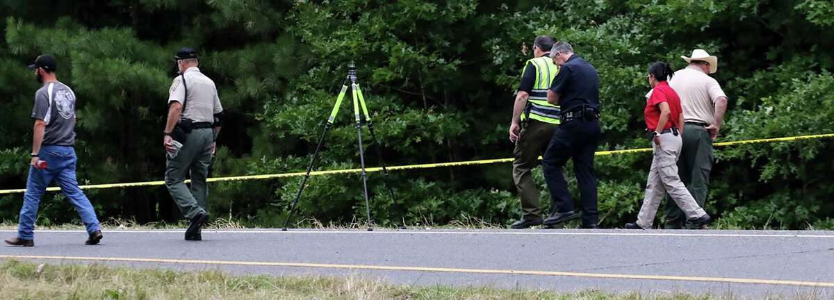 Police officers investigate the remains of a body that was found by workers cutting grass on Friday, May 31, 2019 near Hope, Ark. The remains were found in trash bags found off the Fulton exit (exit 18) of Interstate 30 near Hope.
