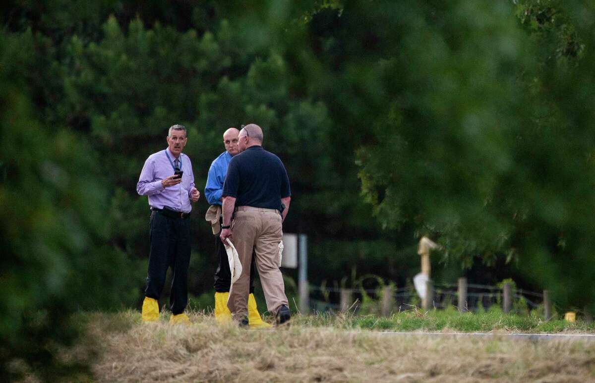 Houston Police homicide detectives and local officials investigate the scene where human remains were discovered in a grassy embankment next to the on-ramp of I-30 East toward Hope, Arkansas Friday, May 31, 2019. Hempstead Sheriff James Singleton obtained a court order that allows Houston Police to fly back back the remains.