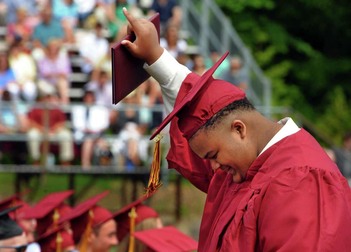 Graduate Tyerre Williams points skyward after getting his diploma during St. Joseph's Commencement Exercies in Trumbull, Conn., on Saturday June 1, 2019.