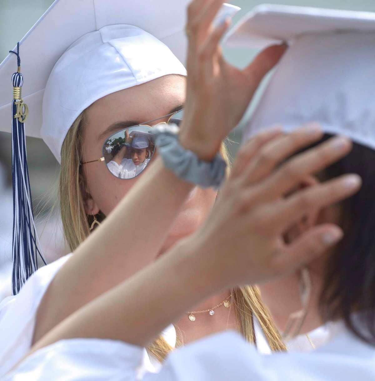 Vanesa Katherine Roma, of Danbury, adjusts the cap of Jessica Dennison, of Danbury, before the Immaculate High School 2019 Commencement. Saturday, June 1, 2019, at the Western Connecticut State University O'Neill Center, Danbury, Conn.
