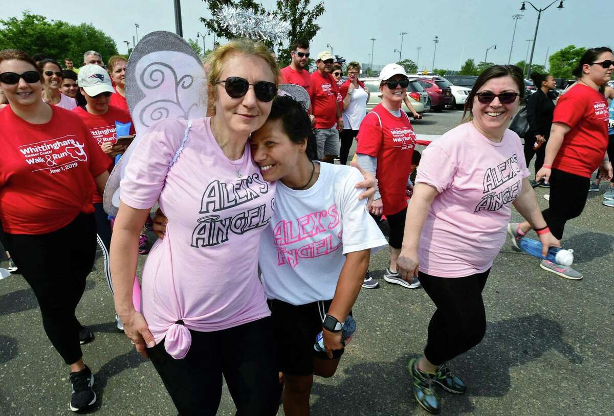 Angie Afentoulides and Alex Afentoulides walk together as patients, supporters and survivors, gather for the 2019 Whittingham Cancer Center Walk & Run Saturday, June 1, 2019, at Calf Pasture Beach in Norwalk, Conn.
