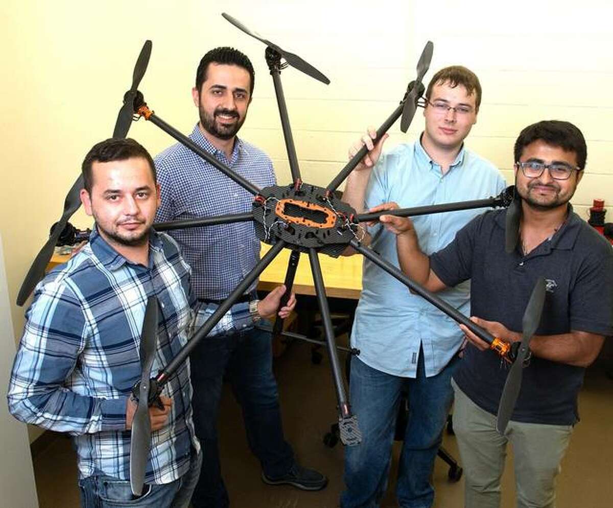 Holding a large drone are, left to right, mechanical engineering graduate student Nedret Ramic, Dr. Nima Lotfi, junior computer science major Jacob Novosad and mechanical engineering alumnus Pratik Lamsal. Lotfi is the faculty advisor for the Drone Club of SIUE.