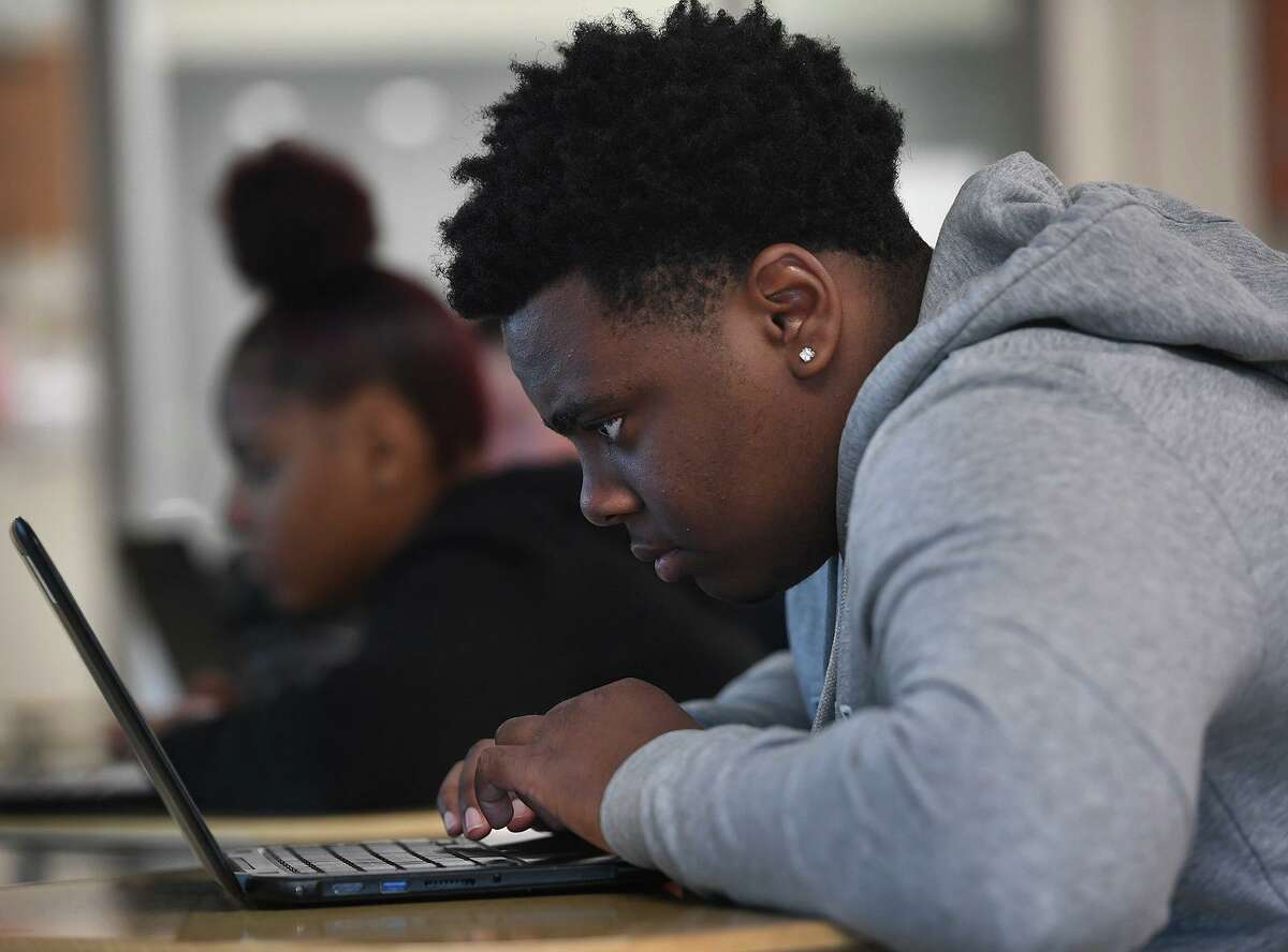 Tenth grader Tayvarie Newton reads a chapter in his online textbook about the Civil Rights Movement in his African American Studies class at Central High School in Bridgeport, Conn. on Tuesday, May 28, 2019.