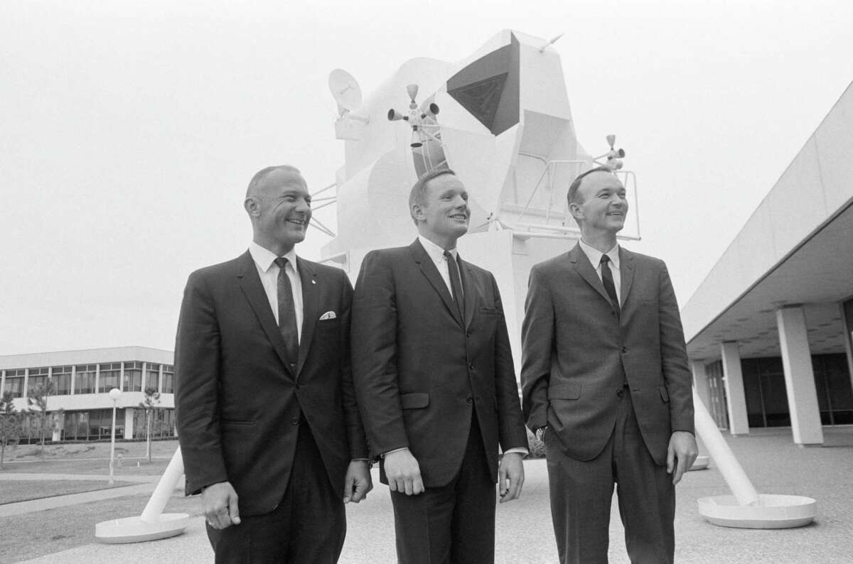 Apollo 11 astronauts Buzz Aldrin, Neil Armstrong and Michael Collins photographed in front of a lunar module (LM) mock-up beside Building 1 following a press conference in the MSC Auditorium Jan. 10, 1969.