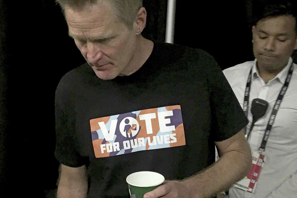 Golden State Warriors head coach Steve Kerr wears a "Vote for our Lives" shirt to a news conference before Game 2 of basketball's NBA Finals against the Toronto Raptors in Toronto, Sunday, June 2, 2019. (Neil Davidson/The Canadian Press via AP)