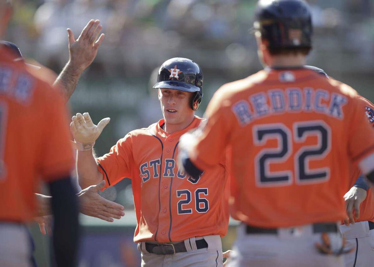Houston Astros' Myles Straw (26) celebrates after scoring against the Oakland Athletics in the 12th inning of a baseball game Sunday, June 2, 2019, in Oakland, Calif. (AP Photo/Ben Margot)