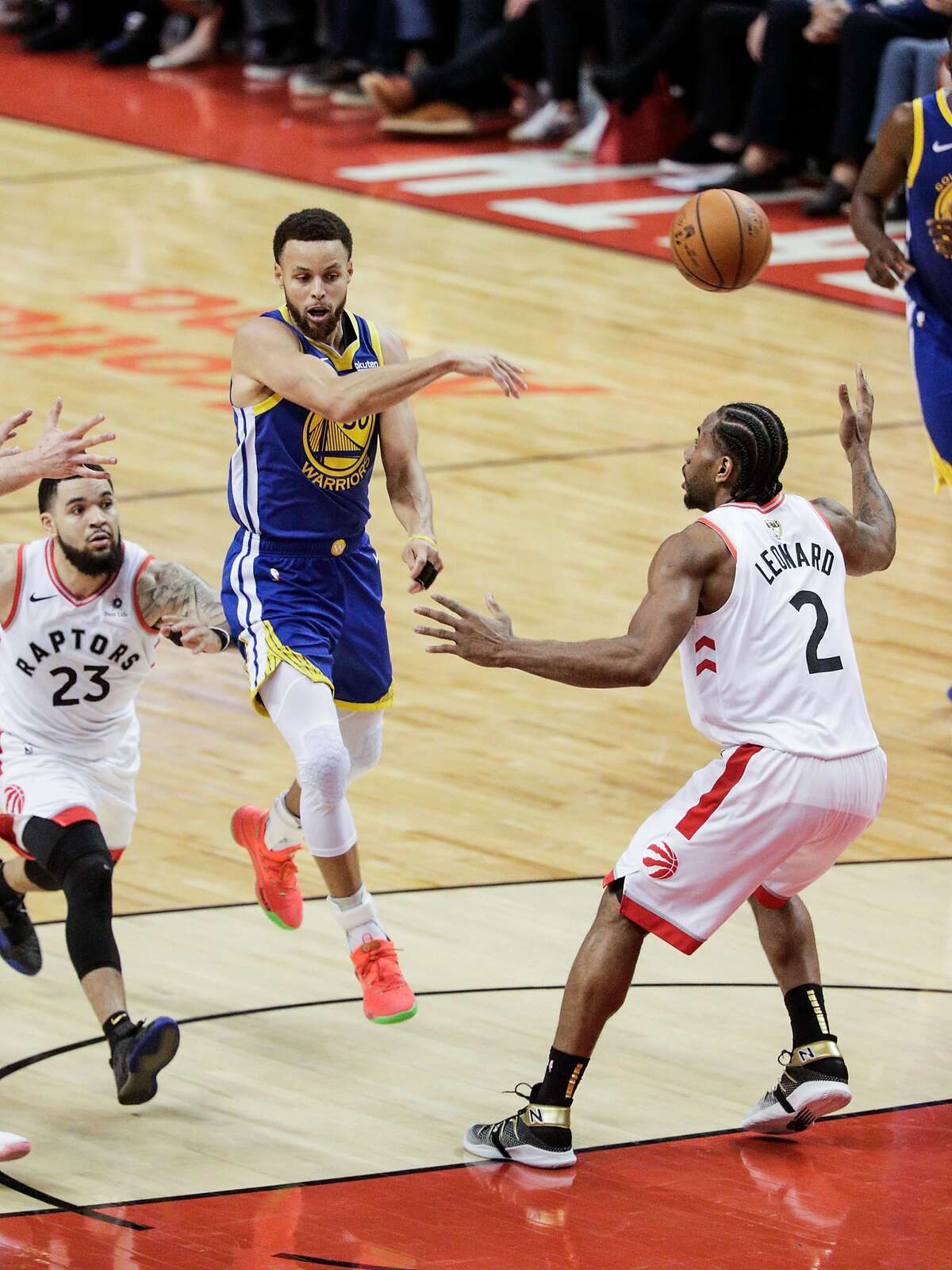 Golden State Warriors’ Stephen Curry throws a no-look pass past Toronto Raptors’ Kawhi Leonard in the third quarter during game 2 of the NBA Finals between the Golden State Warriors and the Toronto Raptors at Scotiabank Arena on Sunday, June 2, 2019 in Toronto, Ontario, Canada.