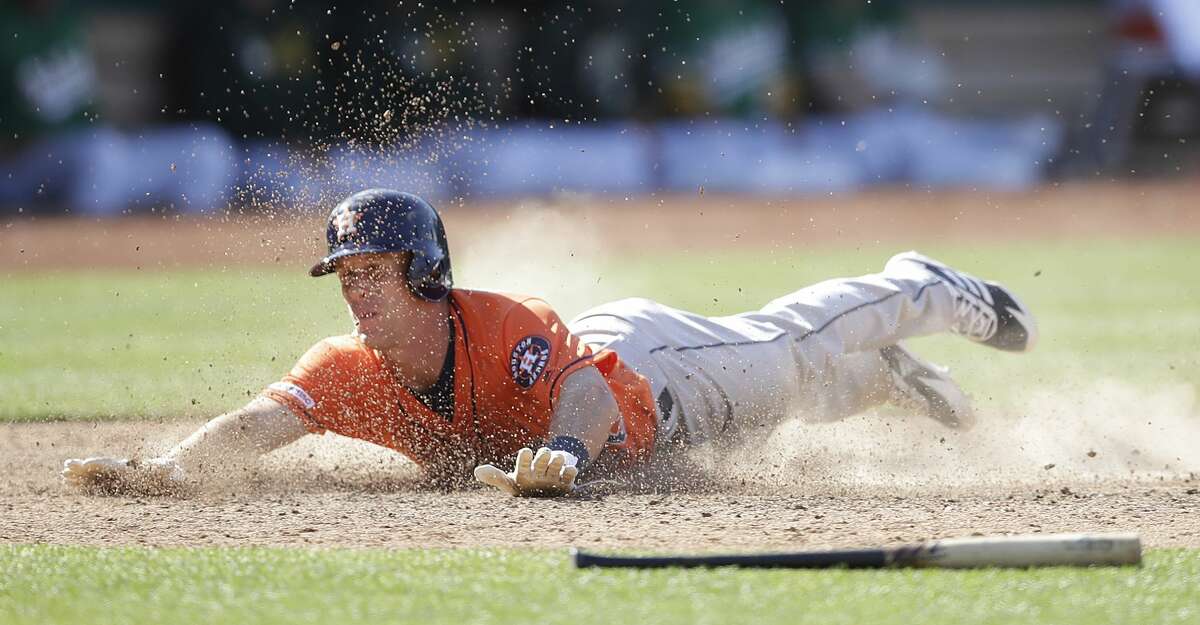 Houston Astros' Myles Straw slides to score against the Oakland Athletics in the 12th inning of a baseball game Sunday, June 2, 2019, in Oakland, Calif. (AP Photo/Ben Margot)