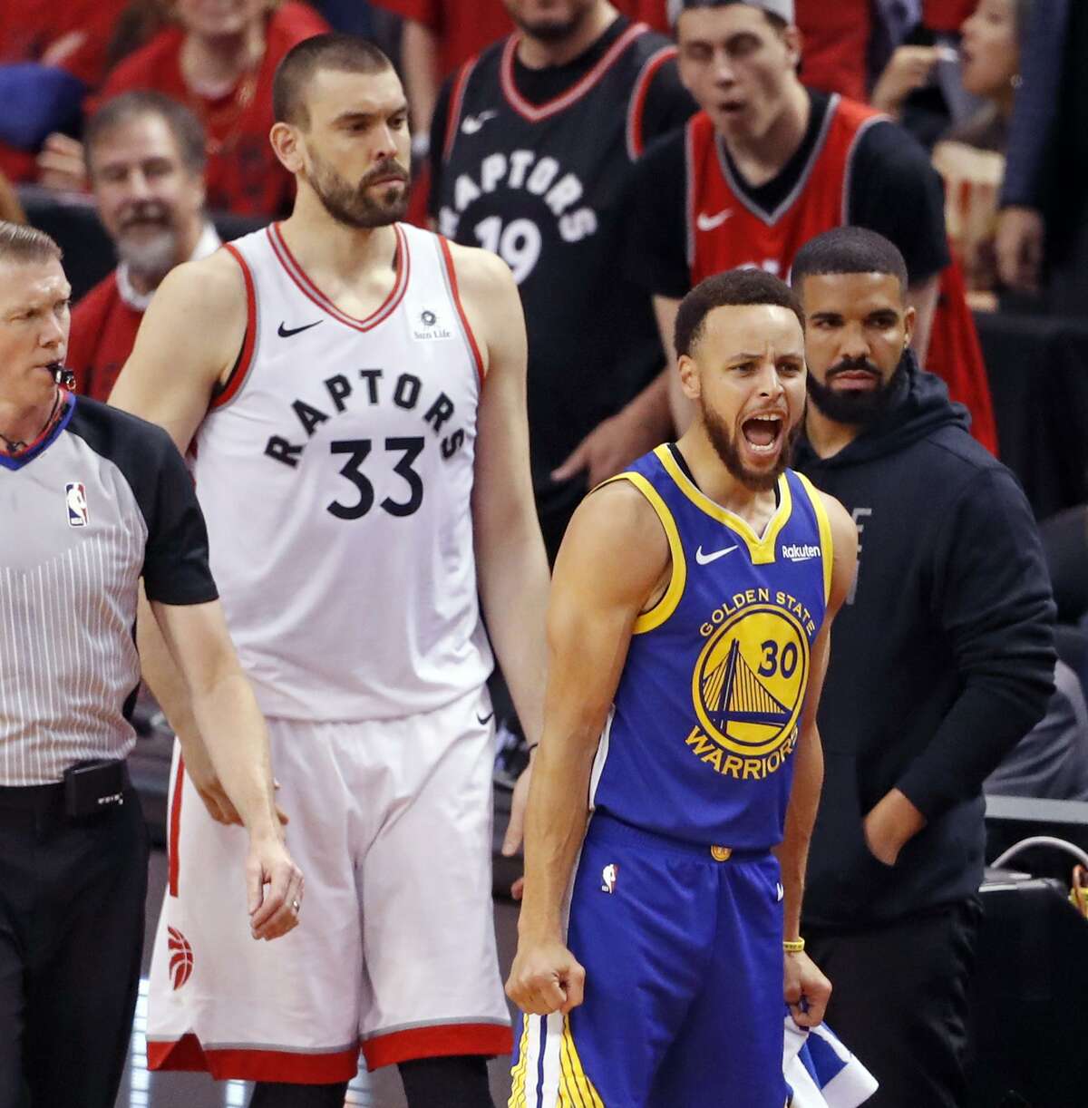 Golden State Warriors' Stephen Curry reacts to Quinn Cook's 3-pointer during 109-104 win over Toronto Raptors in NBA Finals' Game 2 at ScotiaBank Arena in Toronto, Ontario, Canada, on Sunday, June 2, 2019.