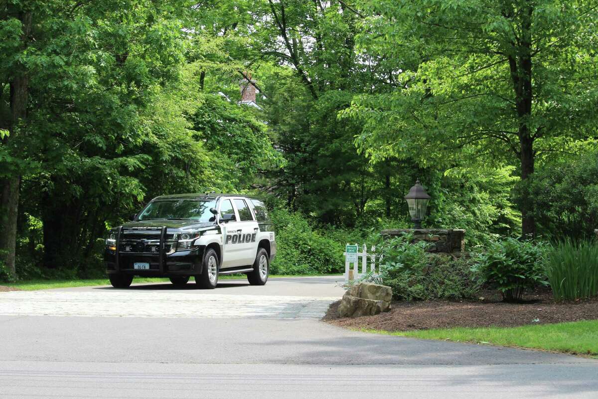 A Farmington police cruiser leaves the private road leading to Fotis Dulos’ home, which has been the target of a search warrant in the disppearance of his estranged wife, Jennifer Dulos.