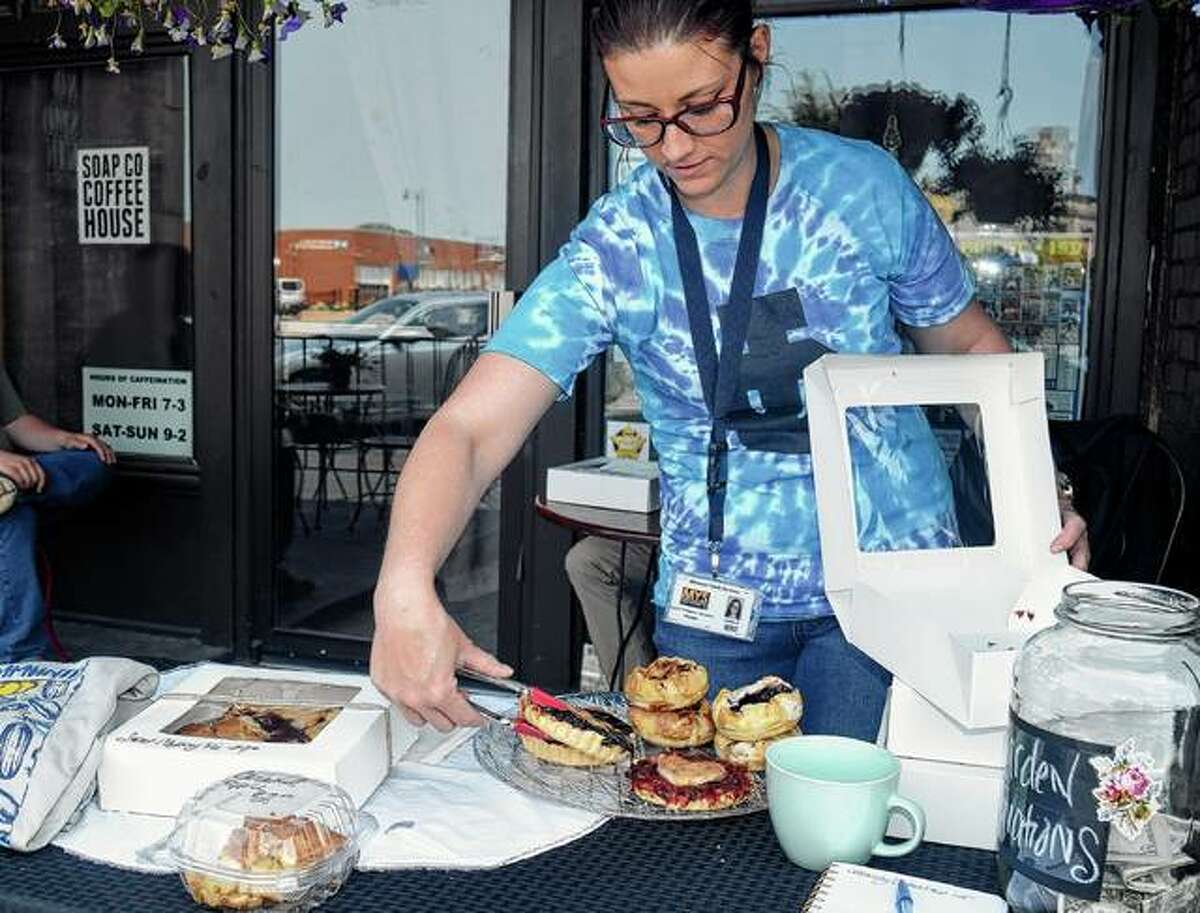 Kelsie Kaylor helps organize pies Saturday during the Jacksonville Community Garden Initiative pie sale to raise money for a waterline.