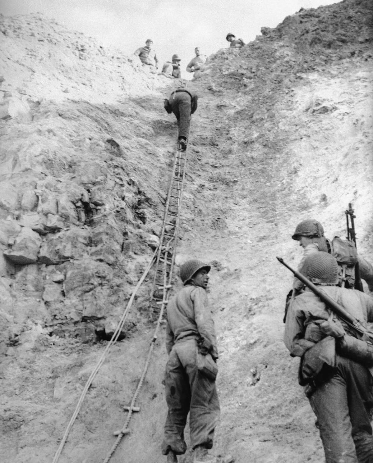 U.S. Army Rangers show off the ladders they used to scale the cliffs at Pointe du Hoc in France on June 6, 1944.