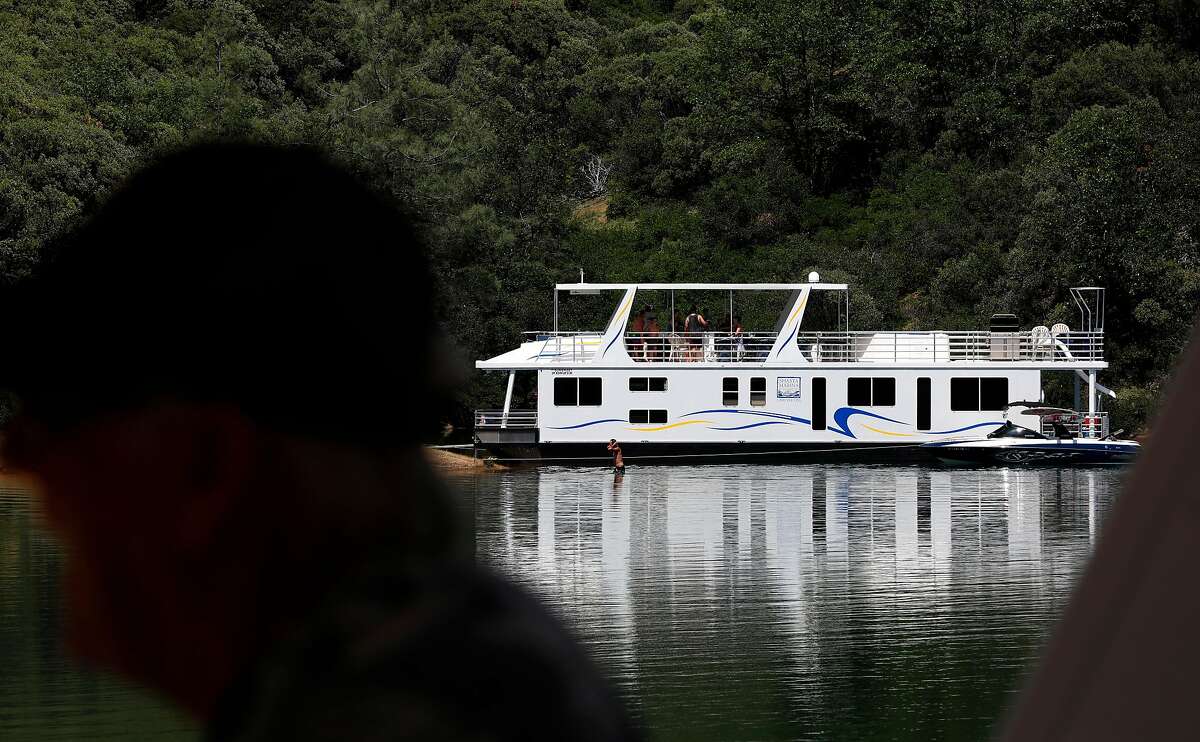 A houseboat pulled up into a quiet cove on Shasta Lake, Ca., as seen on Friday May 31, 2019.