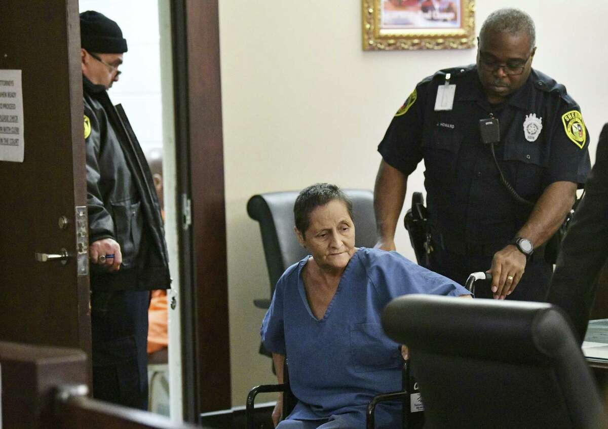 Beatrice Sampayo, 64, who is accused of helping cover up the death of her 8-month-old grandson, King Jay Davila, is wheeled through the courtroom during a bond hearing at which her bond was reduced from $250,000 to $50,000 by Judge Andrew Carruthers in Magistrate Court on Friday, Feb. 8, 2019.